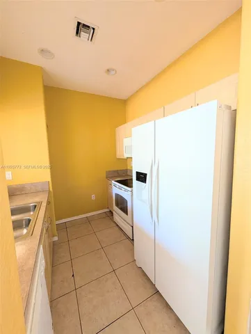 a kitchen with a refrigerator sink and stove