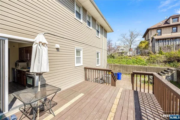 a view of a house with wooden deck