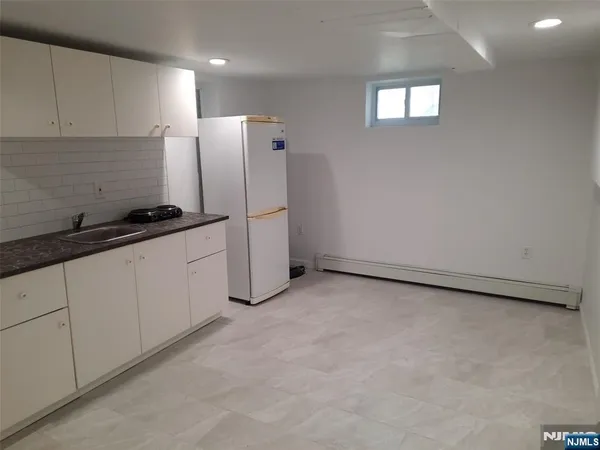 a kitchen with refrigerator and window