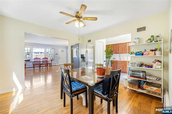 a dining room with furniture and wooden floor