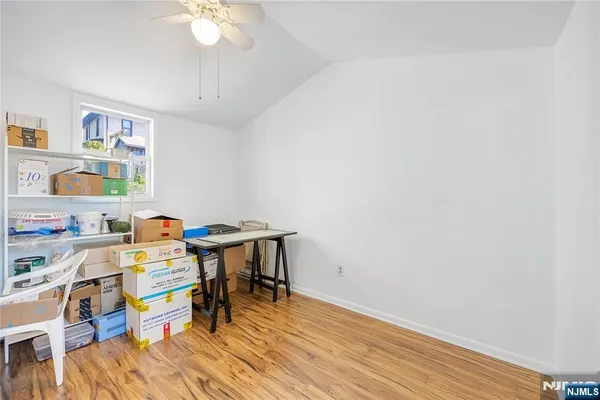 a view of a workspace with furniture and wooden floor