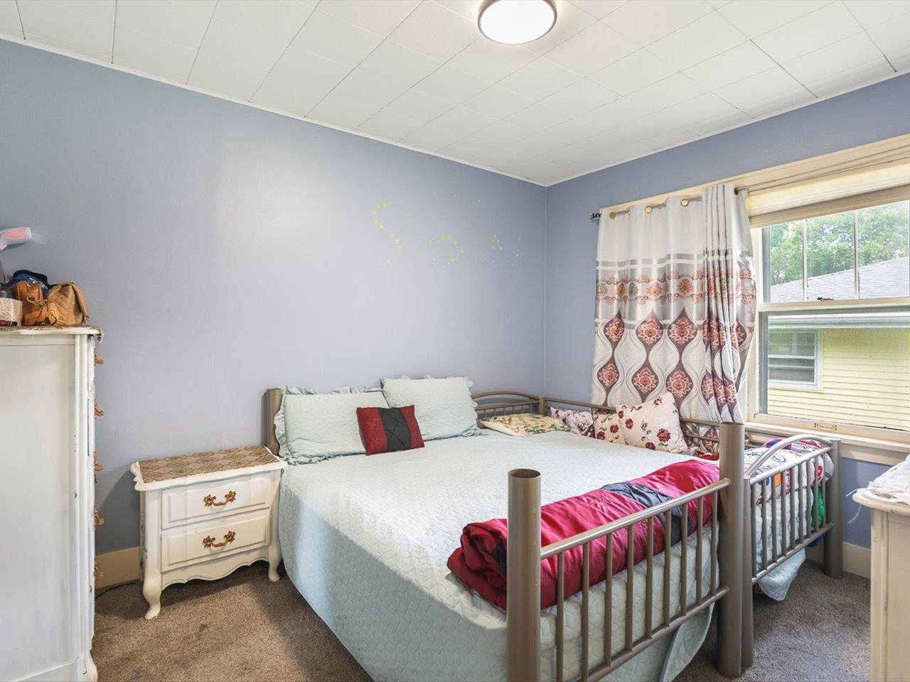1247 West Logan Street Freeport, IL 61032 - Photo 18 of 34 a bedroom with a bed and a window
