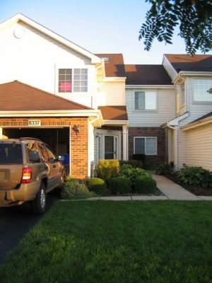 a view of house with outdoor space and parking