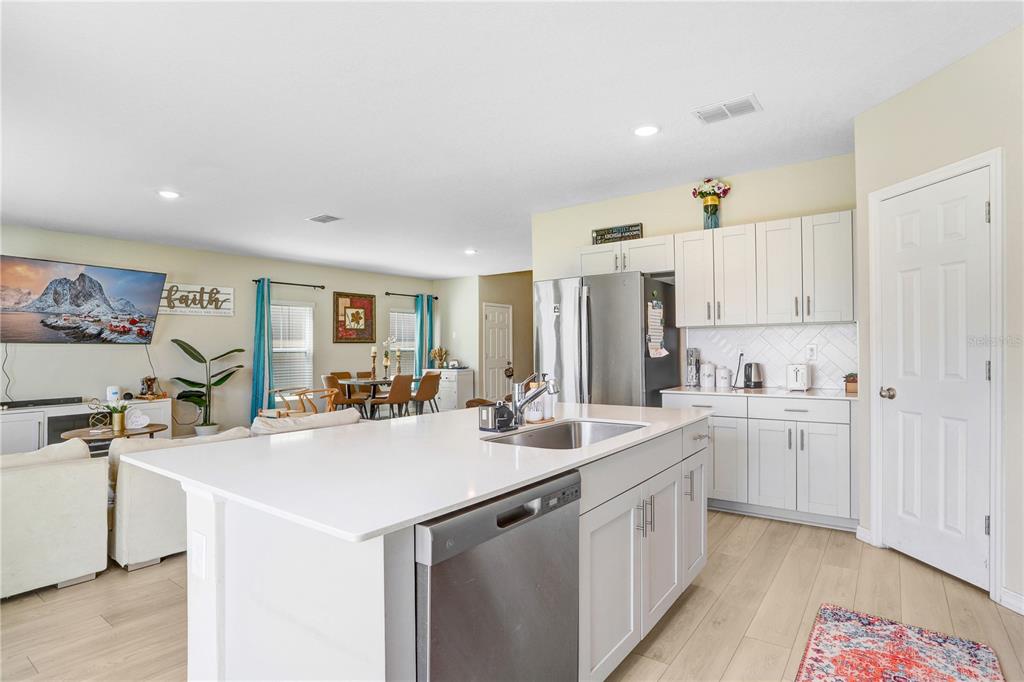 7704 Twinleaf Ter Way Parrish, FL 34219 - Photo 11 of 31 a kitchen with sink cabinets and refrigerator