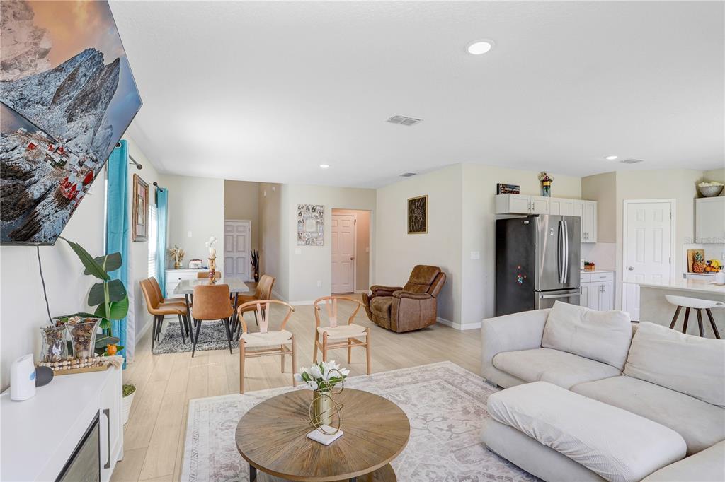 7704 Twinleaf Ter Way Parrish, FL 34219 - Photo 17 of 31 a living room with furniture kitchen view and a chandelier