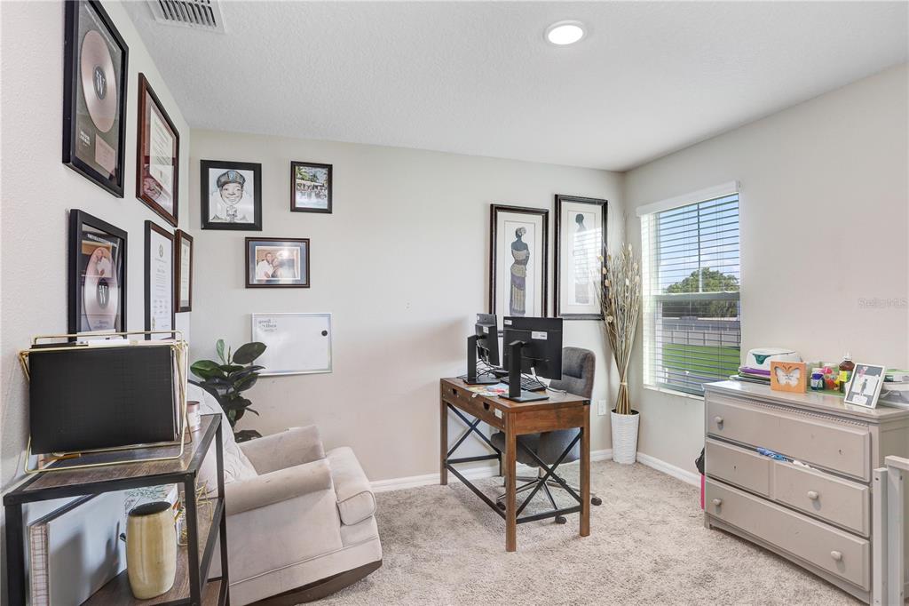 7704 Twinleaf Ter Way Parrish, FL 34219 - Photo 21 of 31 a living room with furniture and a flat screen tv