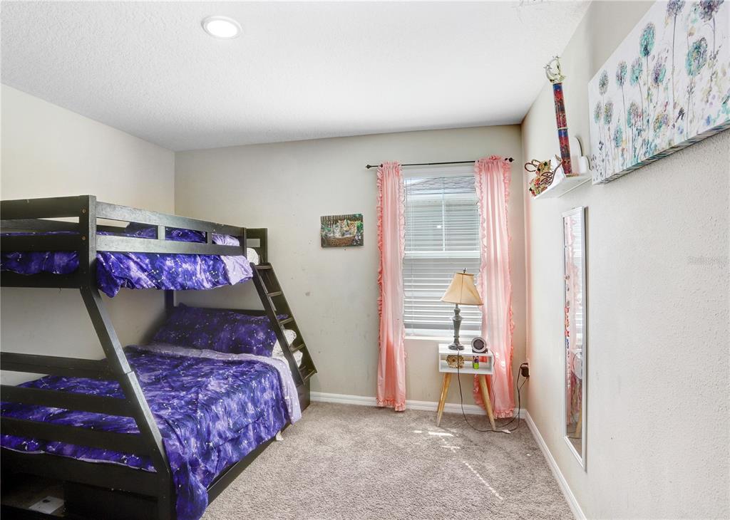 7704 Twinleaf Ter Way Parrish, FL 34219 - Photo 22 of 31 a bedroom with a bed and a window