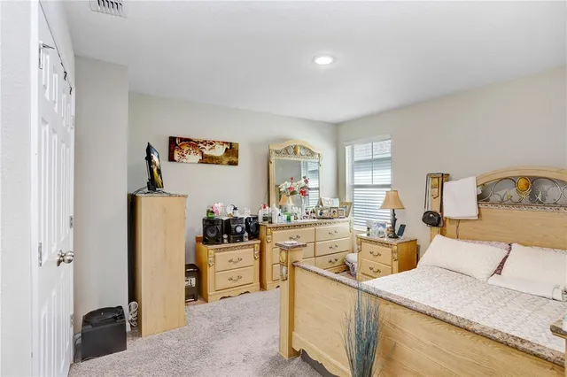 a bedroom with a bed and dresser