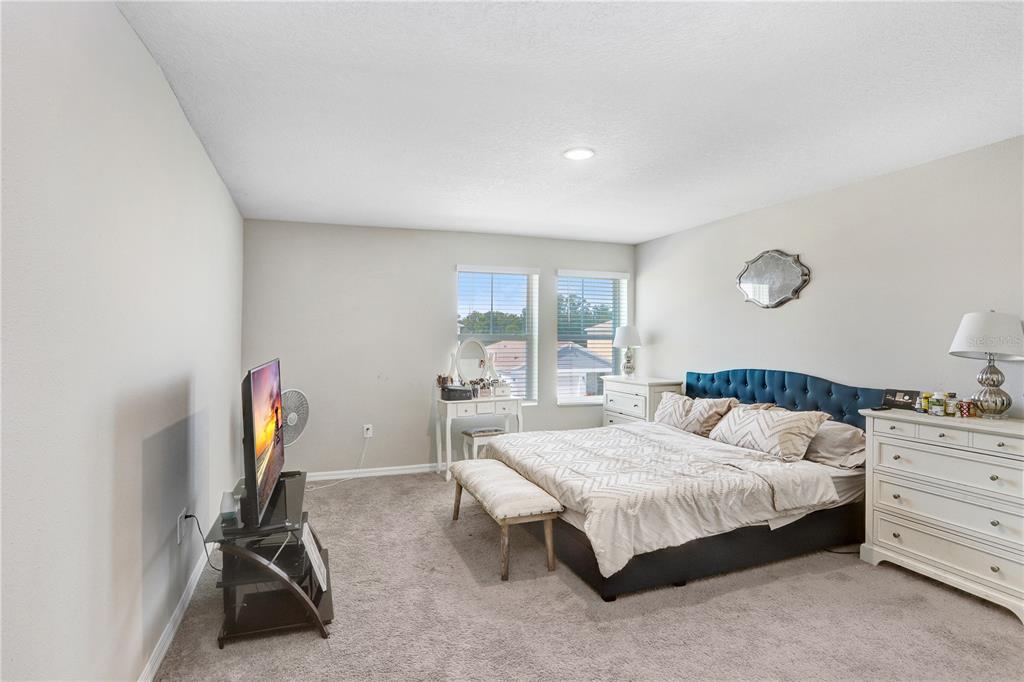 7704 Twinleaf Ter Way Parrish, FL 34219 - Photo 25 of 31 a bedroom with a bed and dresser