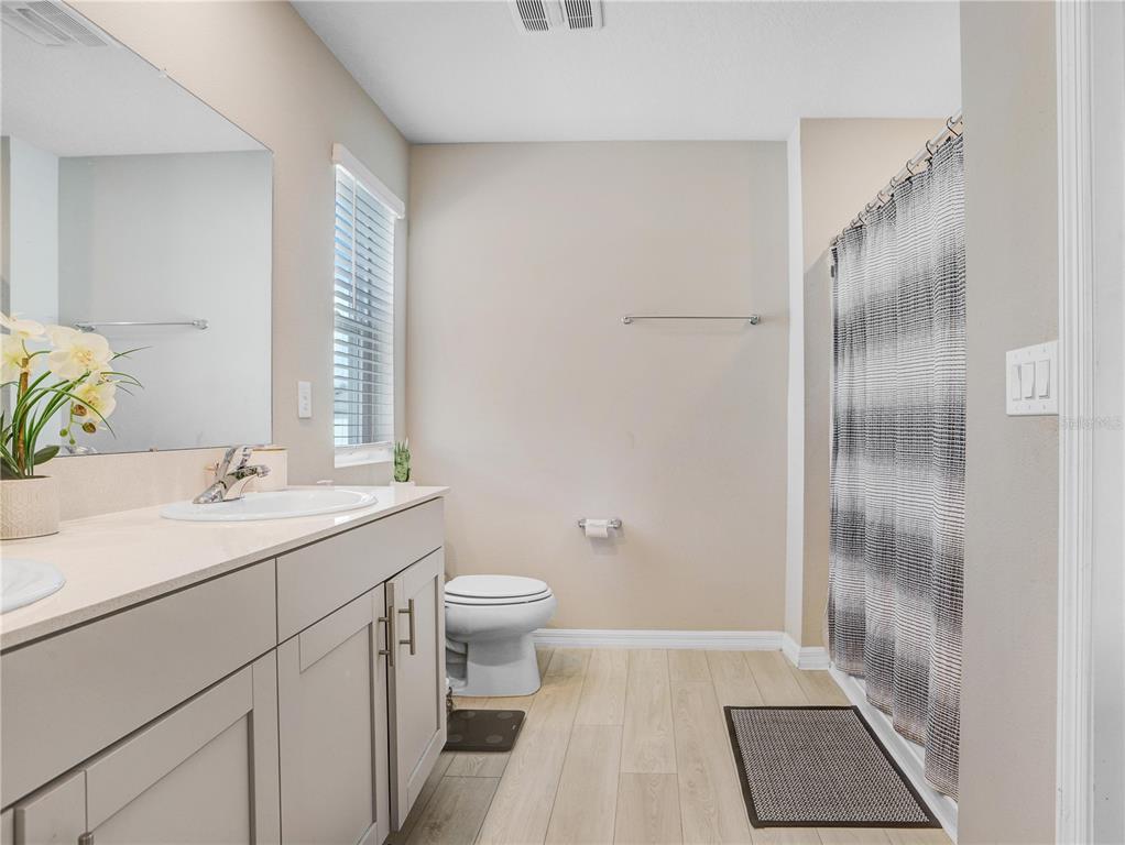 7704 Twinleaf Ter Way Parrish, FL 34219 - Photo 27 of 31 a bathroom with a sink a toilet and shower