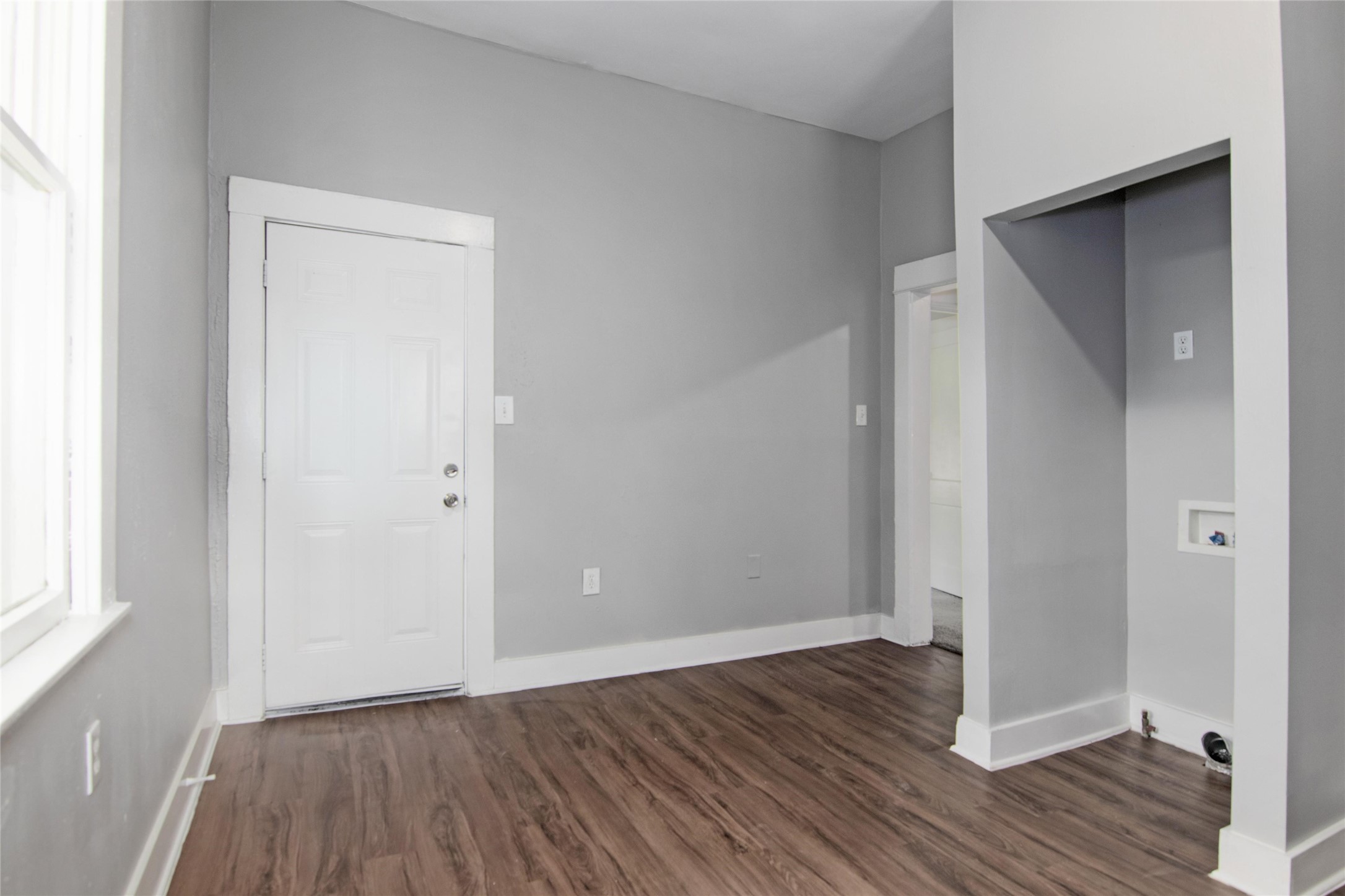 3220 Melbourne Street Houston, TX 77026 - Photo 14 of 23 a view of an empty room with wooden floor and a window