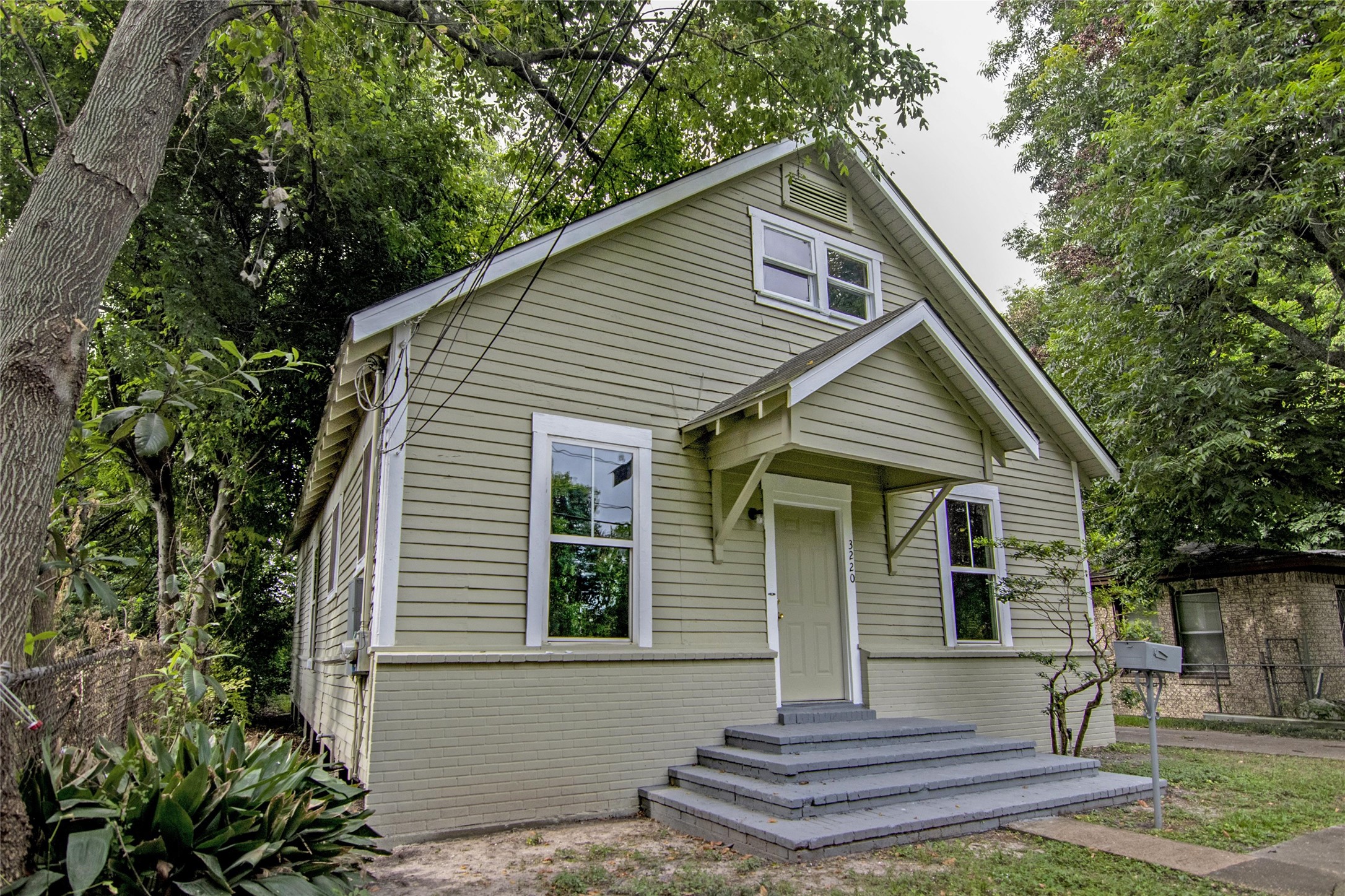 3220 Melbourne Street Houston, TX 77026 - Photo 2 of 23 a front view of a house with a garden