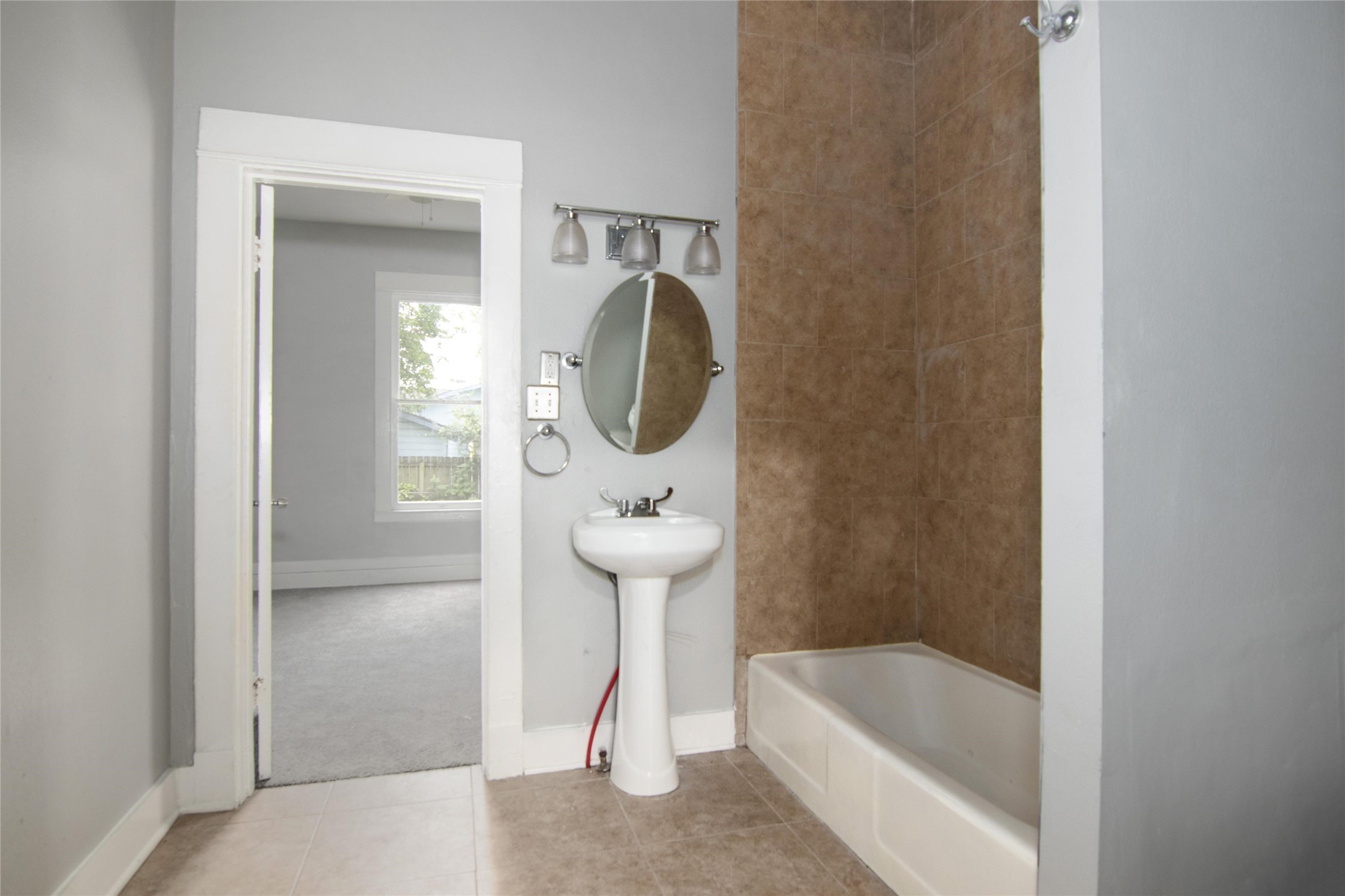 3220 Melbourne Street Houston, TX 77026 - Photo 10 of 23 a bathroom with a tub and a shower