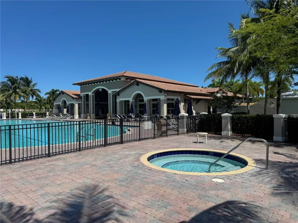 a view of a house with swimming pool and porch