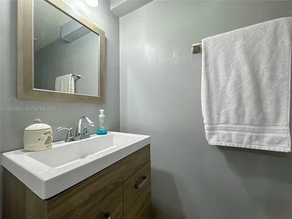 a bathroom with a sink and a mirror