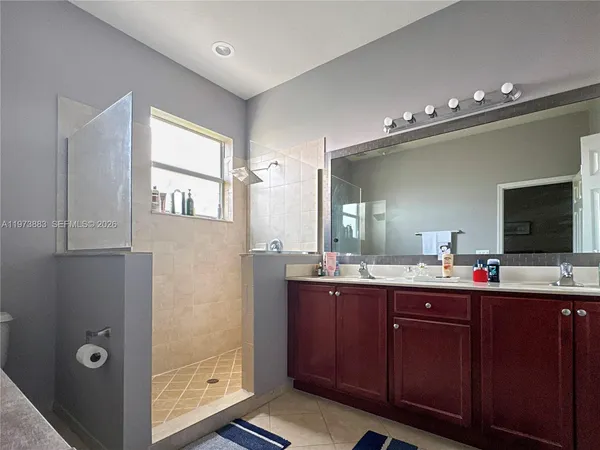 a bathroom with a double vanity sink and a mirror