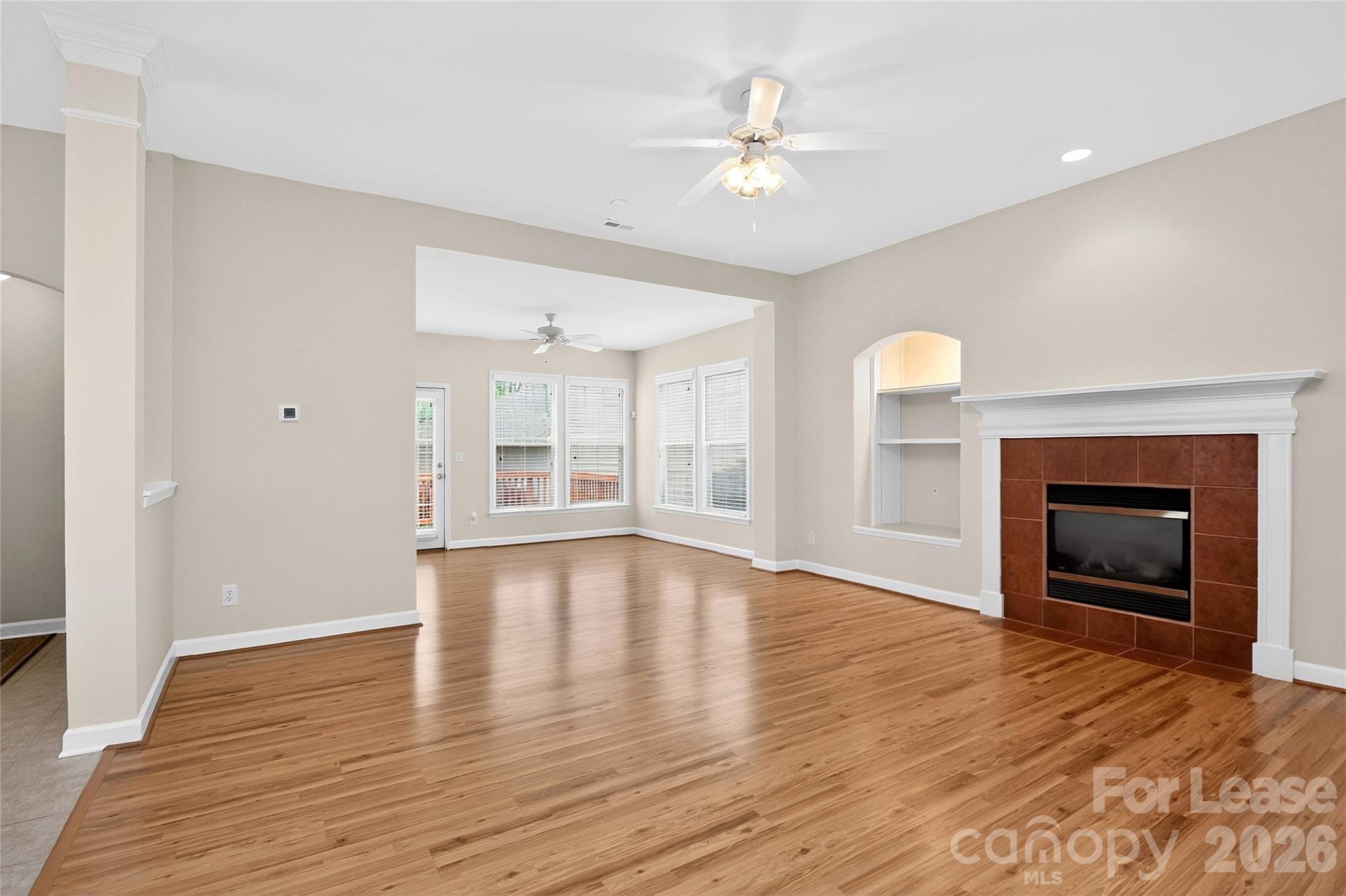 9315 Rosalyn Glen Road Cornelius, NC 28031 - Photo 11 of 35 a view of an empty room with a fireplace and a window