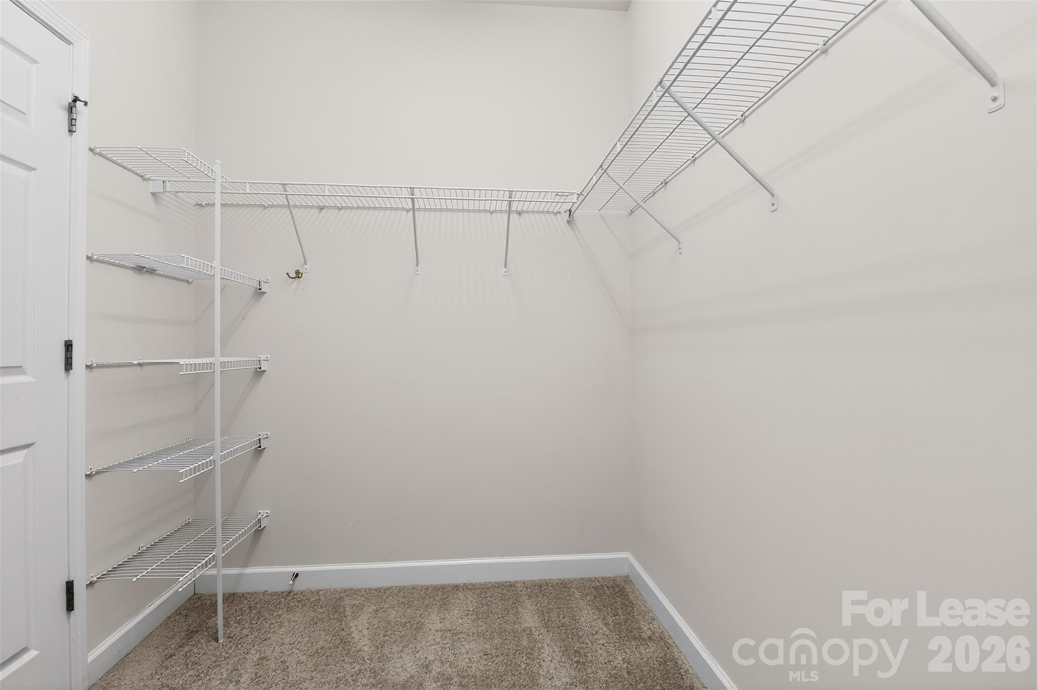 9315 Rosalyn Glen Road Cornelius, NC 28031 - Photo 24 of 35 a view of walk in closet with empty racks