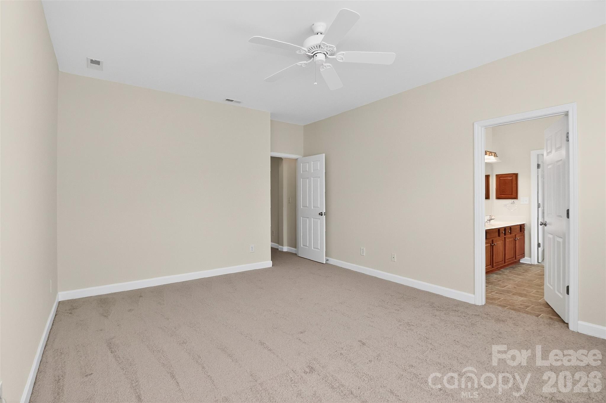9315 Rosalyn Glen Road Cornelius, NC 28031 - Photo 30 of 35 an empty room with closet and a ceiling fan