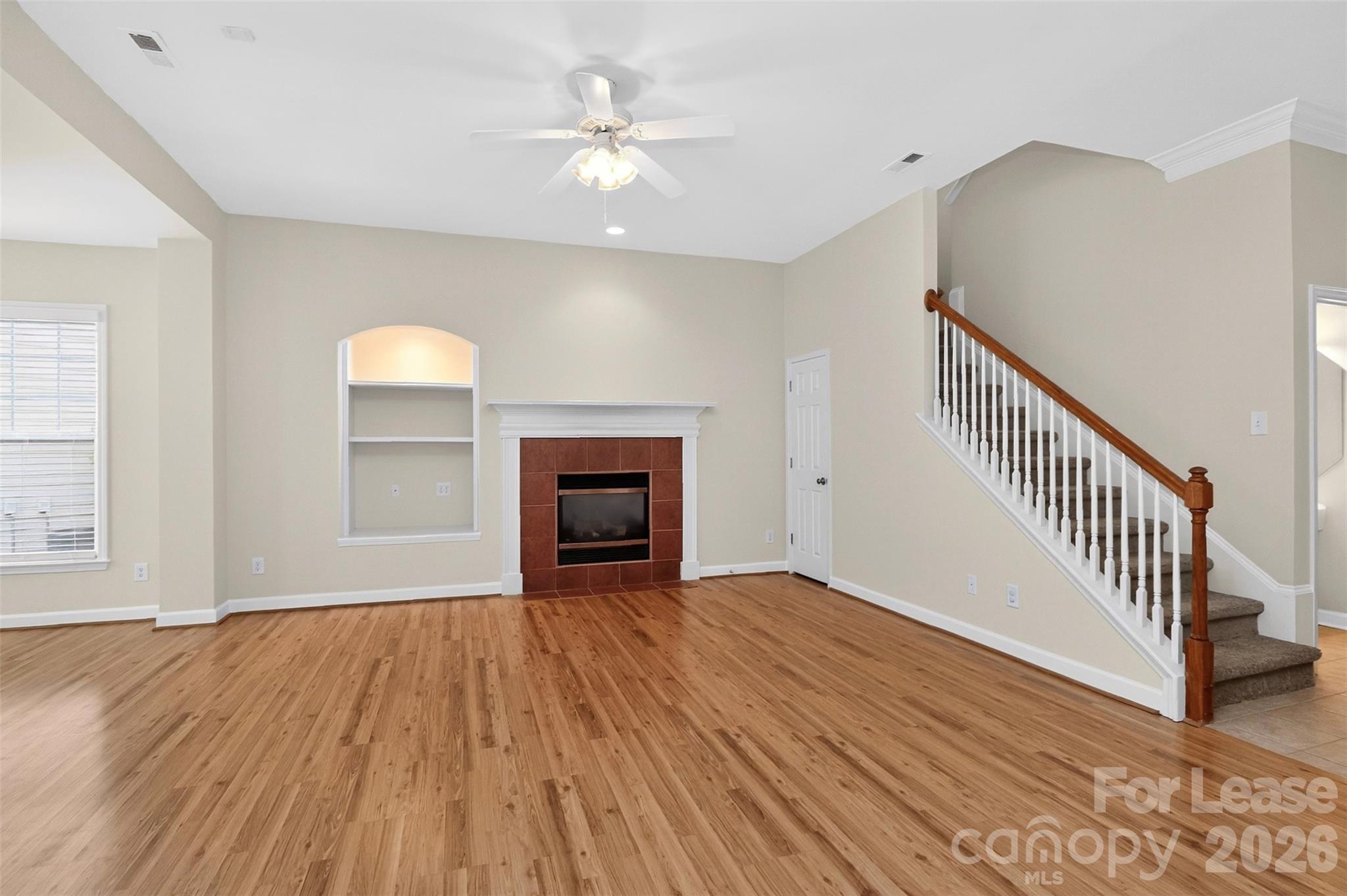 9315 Rosalyn Glen Road Cornelius, NC 28031 - Photo 34 of 35 a view of an empty room with wooden floor and a window