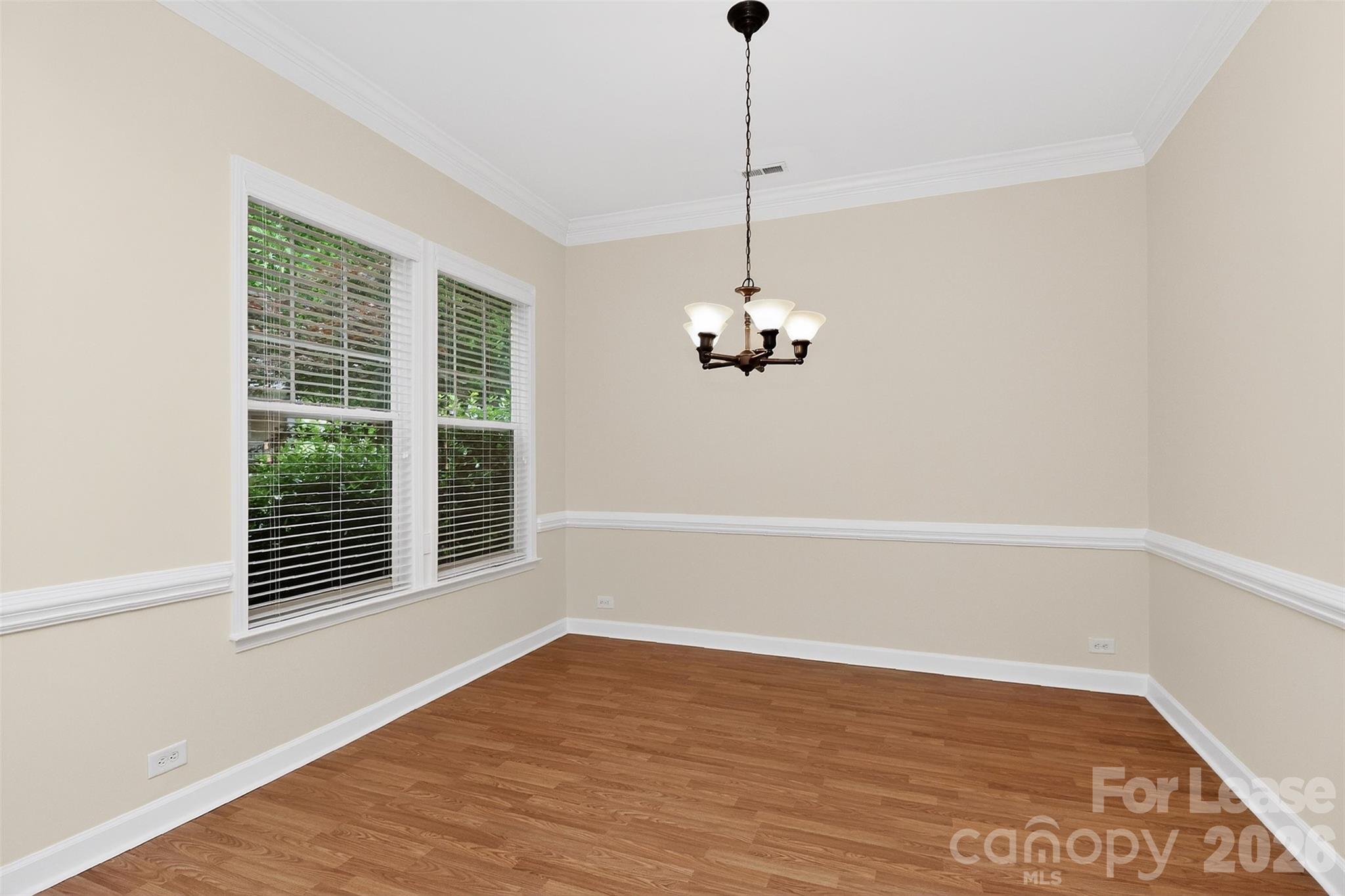9315 Rosalyn Glen Road Cornelius, NC 28031 - Photo 4 of 35 a view of a room with a wooden floor and a window