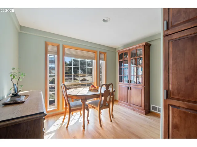 a dining room with furniture and wooden floor