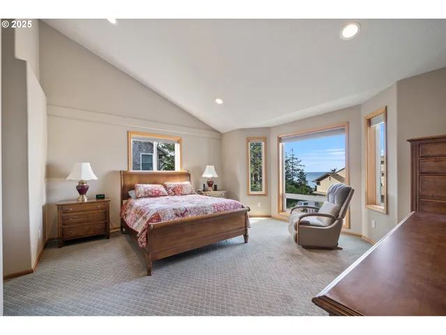 a bedroom with furniture and large windows