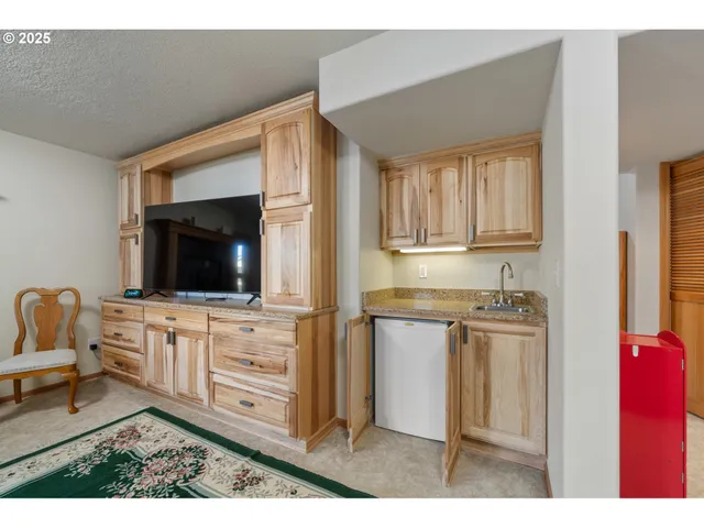 a kitchen with a refrigerator and cabinets