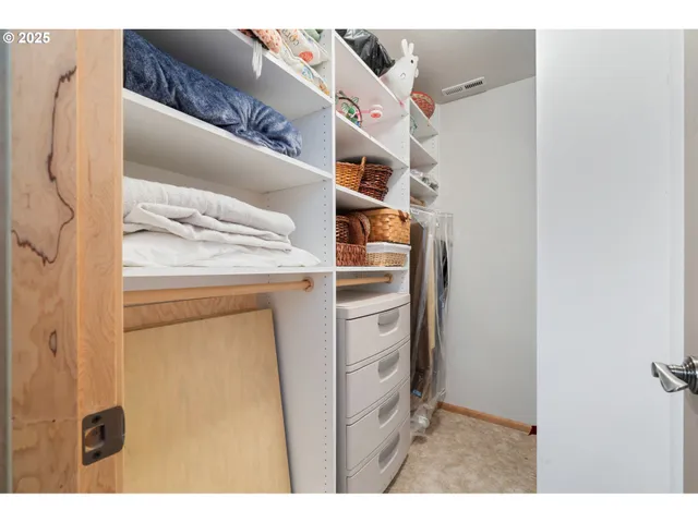 a bedroom with a bed window and dresser