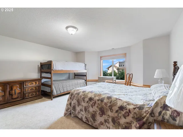 a spacious bedroom with a bed and a view of bedroom