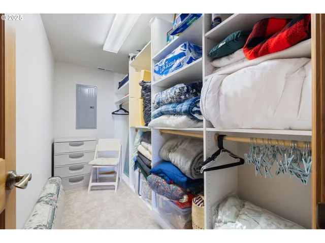 a bathroom with a granite countertop sink a toilet a large mirror and shower