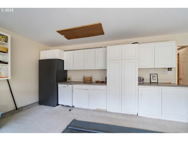 a aerial view of a house next to a yard