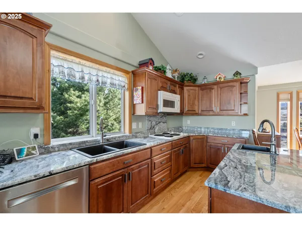 a kitchen with granite countertop a sink and a stove