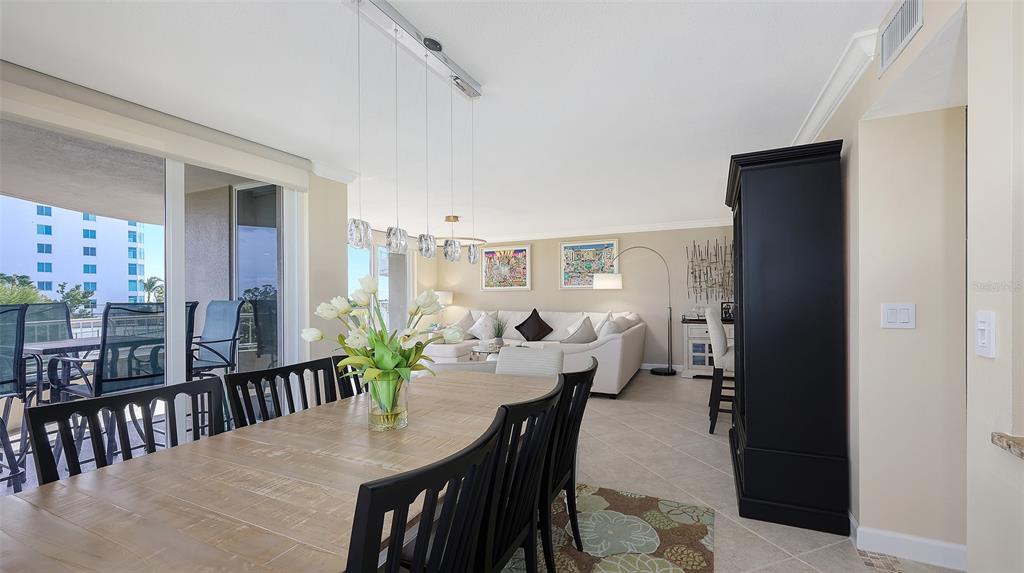 775 Longboat Club Road, Unit 304 Longboat Key, FL 34228 - Photo 15 of 52 a view of a dining room with furniture window and wooden floor