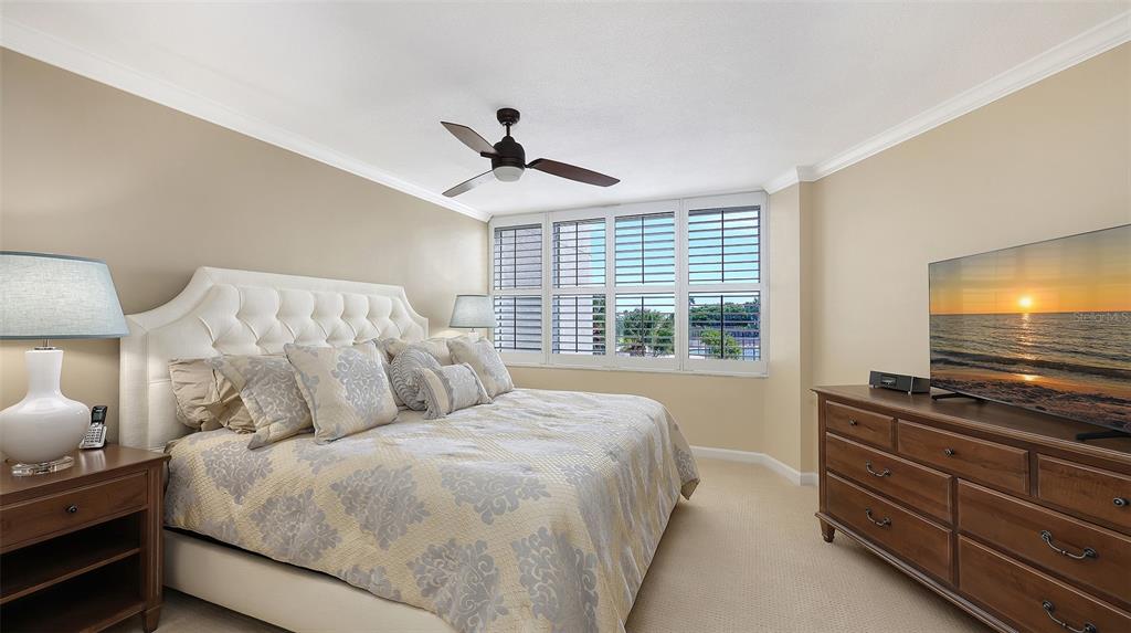 775 Longboat Club Road, Unit 304 Longboat Key, FL 34228 - Photo 26 of 52 a bedroom with a bed and a flat screen tv
