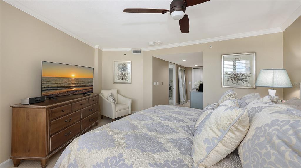 775 Longboat Club Road, Unit 304 Longboat Key, FL 34228 - Photo 28 of 52 a bedroom with a bed and flat screen tv