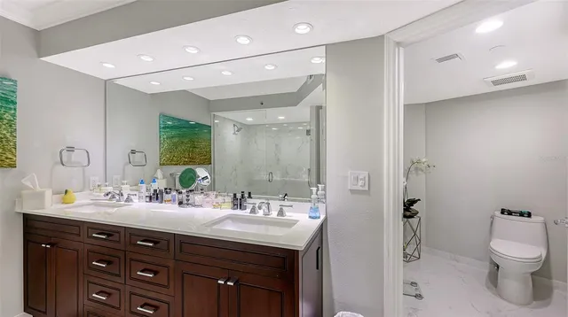a bathroom with a double vanity sink a mirror and a shower