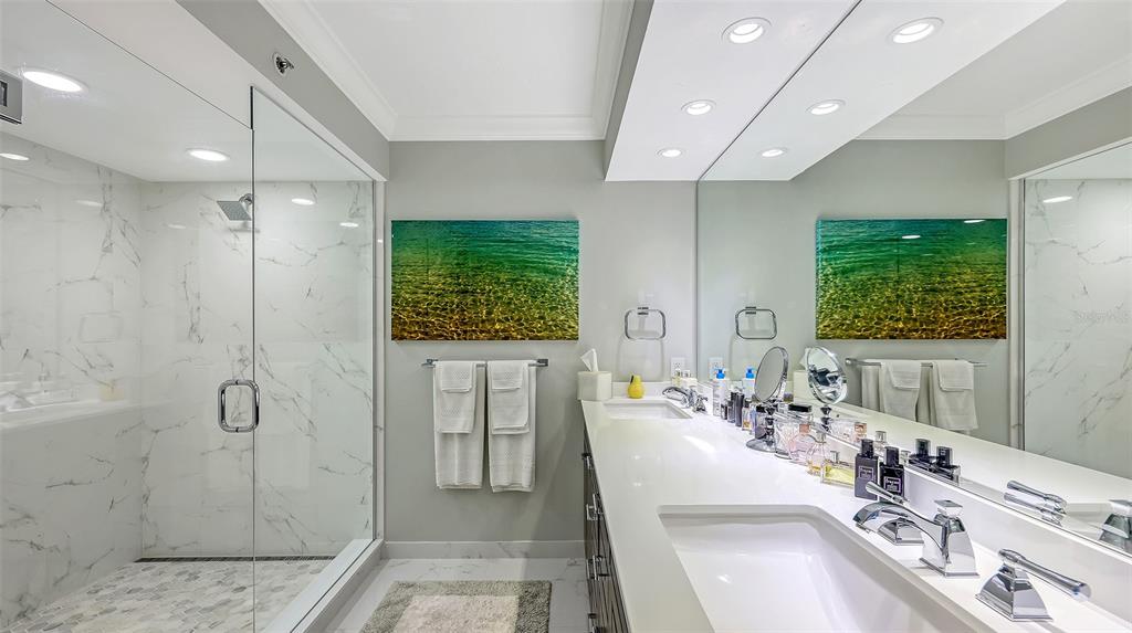 775 Longboat Club Road, Unit 304 Longboat Key, FL 34228 - Photo 30 of 52 a bathroom with a double vanity sink a mirror and a shower