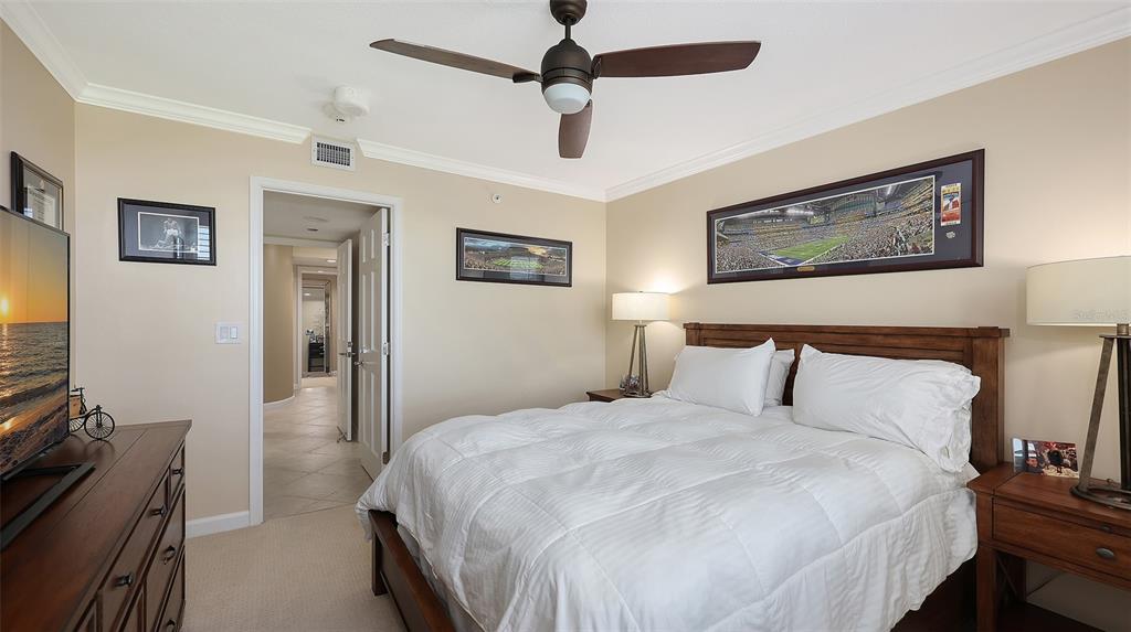 775 Longboat Club Road, Unit 304 Longboat Key, FL 34228 - Photo 31 of 52 a bedroom with a bed and a flat screen tv