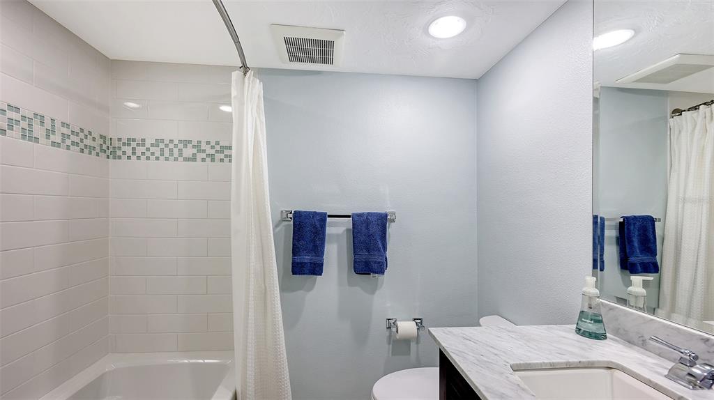 775 Longboat Club Road, Unit 304 Longboat Key, FL 34228 - Photo 33 of 52 a bathroom with a granite countertop sink a toilet and shower