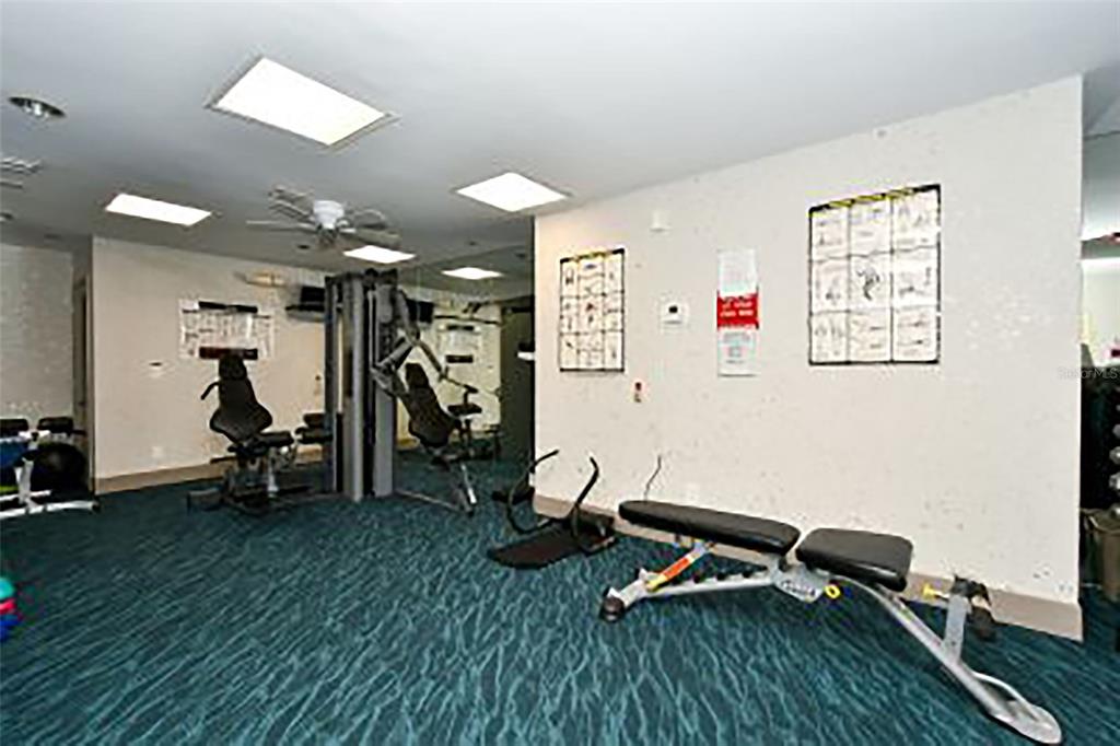 775 Longboat Club Road, Unit 304 Longboat Key, FL 34228 - Photo 48 of 52 a room with gym equipment and a table