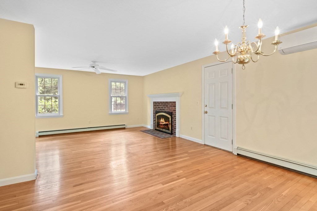 50 Nye Road Barnstable, MA 02632 - Photo 4 of 13 a view of a livingroom with a fireplace a chandelier and wooden floor