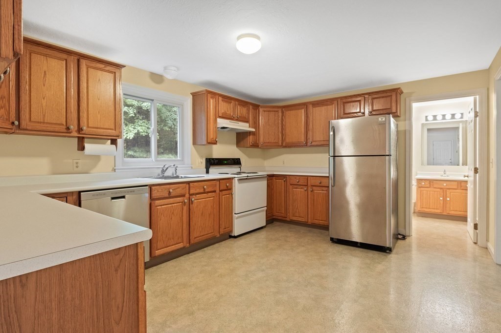 50 Nye Road Barnstable, MA 02632 - Photo 6 of 13 a kitchen with a refrigerator a sink and cabinets