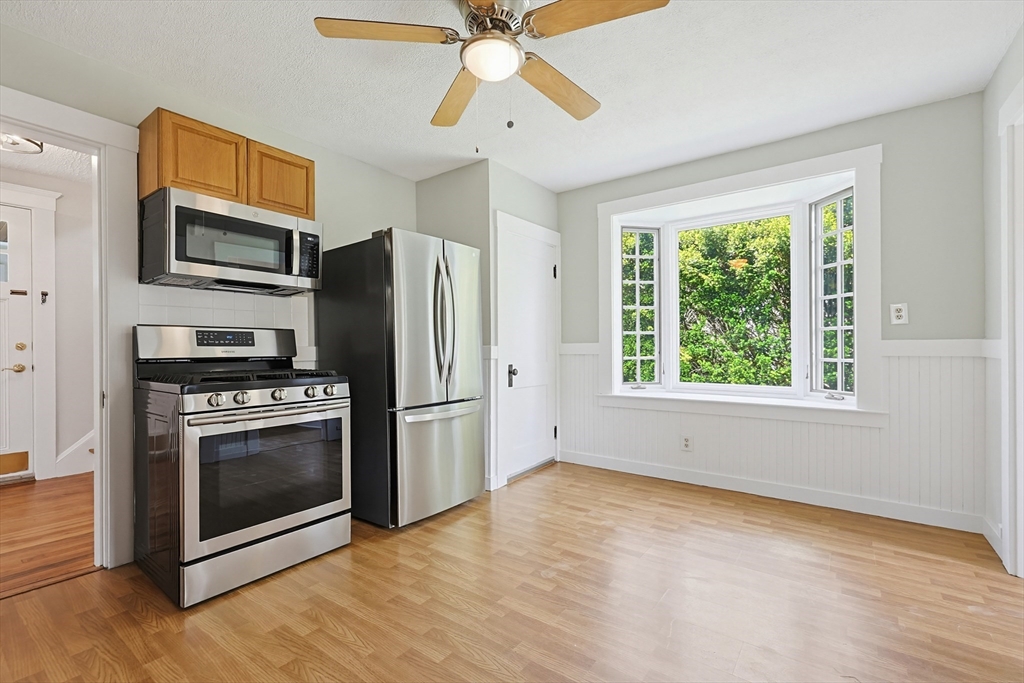 10 Water Street Natick, MA 01760 - Photo 9 of 35 a kitchen with stainless steel appliances a stove a microwave and a hard wood floor