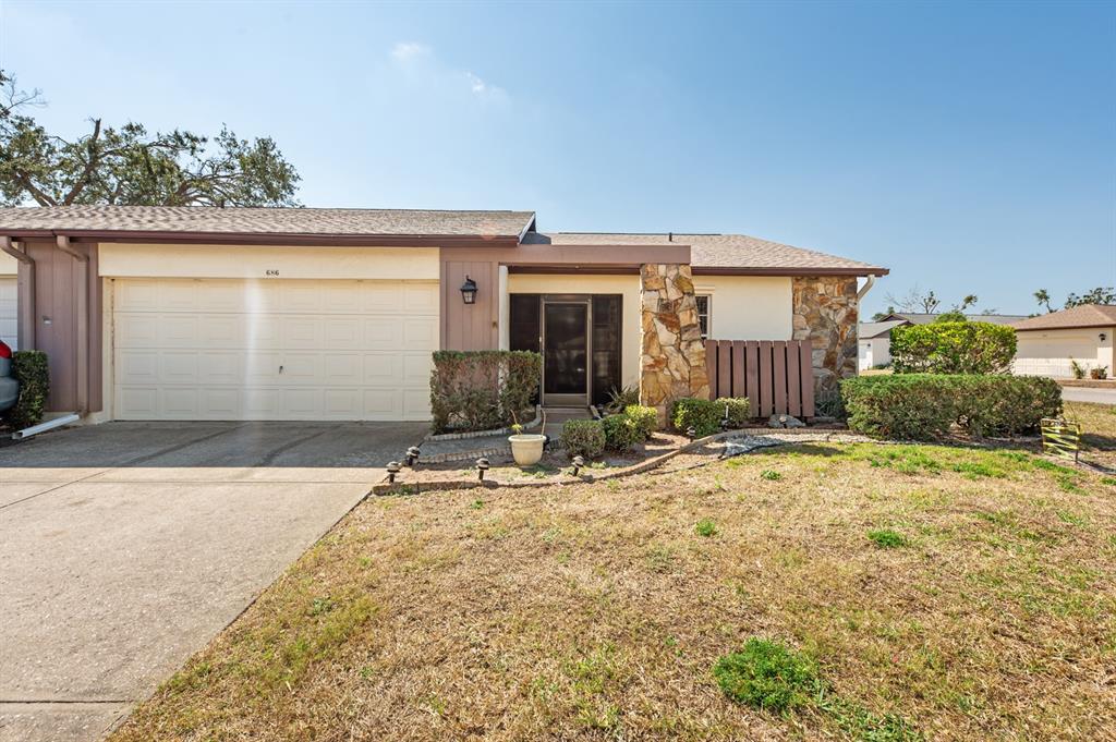 686 Linden Drive, Unit 347 Englewood, FL 34223 - Photo 1 of 47 a front view of a house with garden