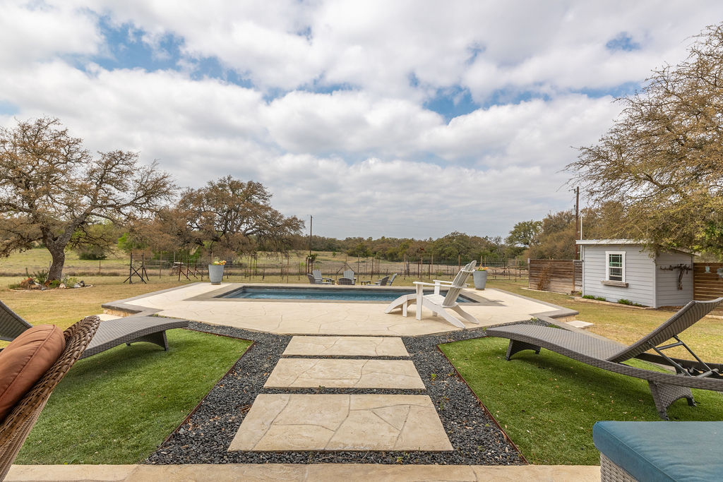 579 Triples Trail Johnson City, TX 78636 - Photo 19 of 39 a view of swimming pool with lounge chair in front of house