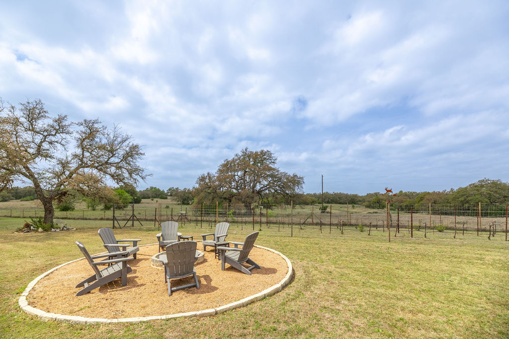 579 Triples Trail Johnson City, TX 78636 - Photo 26 of 39 a view of a lake with houses in the back
