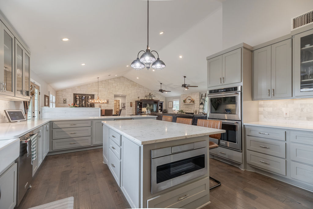 579 Triples Trail Johnson City, TX 78636 - Photo 6 of 39 a kitchen with white cabinets and stainless steel appliances