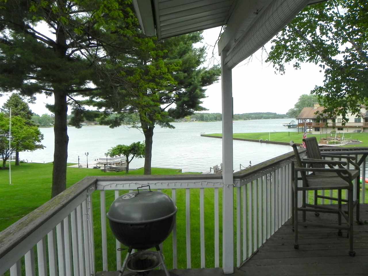 534 Baintree Road Lake Summerset, IL 61019 - Photo 5 of 25 a view of a deck with a table and chairs next to a yard with large tree