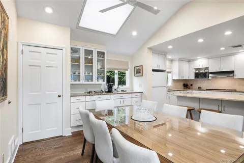a kitchen with white cabinets and refrigerator